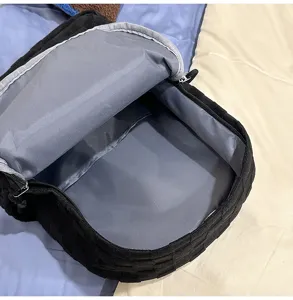 Close-up view of the spacious black plaid backpack interior lining and compartments.