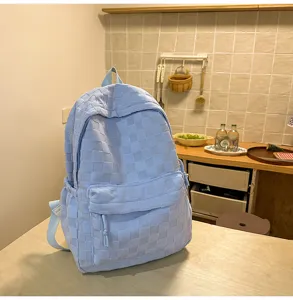 Detailed view of the casual blue plaid backpack with large capacity, perfect for daily student use.