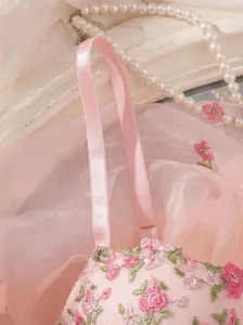 Pink floral embroidered bralette detail showing delicate lace and adjustable straps.