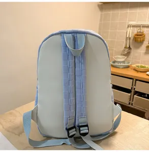 Light blue checkered student school backpack detail view, large capacity casual daily bag.