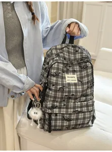 Japanese style casual plaid backpack for students, stylish everyday school bag with cute pendant.