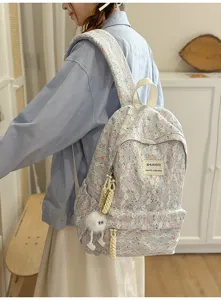 Close-up detail shot of the stylish floral lace backpack worn by model, showing casual style.