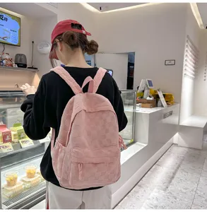 Pink plaid casual backpack worn in a cozy bakery shop, featuring a spacious design.