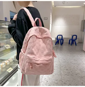 Detailed view of a stylish pink checkered casual backpack featuring a large capacity.