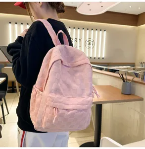 Pink checkered backpack detail view, casual school bag lifestyle shot in cafe, daily use.
