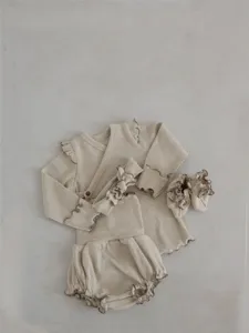 Detailed view of baby ribbed cotton long sleeve top and shorts set with cute ruffles in beige.