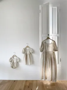 Infant baby girl woven cotton puff sleeve embroidered romper and family matching dresses detail.