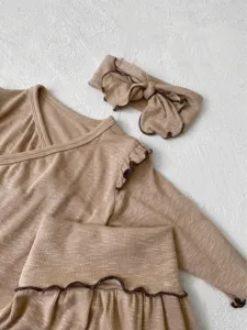 Infant ribbed long sleeve top and pants set with cute bow headband for baby girls detail.