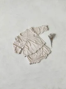 Infant baby sleepwear detail, ribbed long sleeve top and high waist shorts with ruffles.