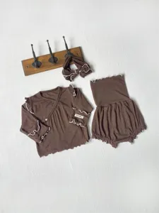 Infant brown long-sleeve top and high-waisted shorts detail, soft cotton baby clothing set.