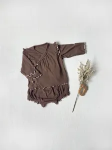 Infant autumn cotton long sleeve top and high waist shorts set detail view with ruffles.
