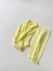 Detailed view of the cute yellow baby cotton long sleeve romper and high waist pants set.
