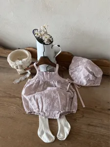 Infant vintage embroidered cotton strap romper bonnet and tights detail view rustic style