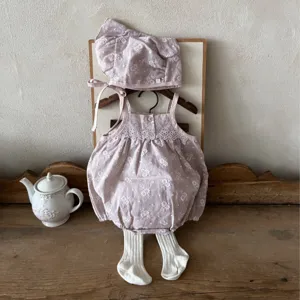 Cute infant baby girl retro floral embroidered cotton strap romper set with matching hat.
