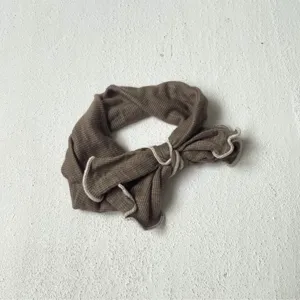 Brown ribbed knit hair band, detailed with white lettuce edge trim and stylish bow knot.
