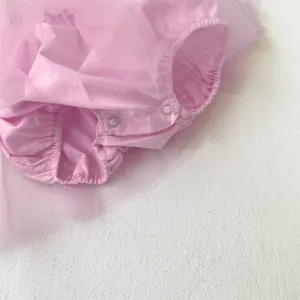 Close up detail of pink baby girl tulle romper skirt, soft mesh fabric and convenient snap closure.