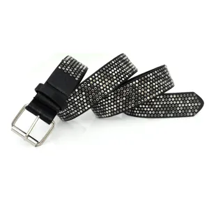 Detail shot of a black women's punk style leather belt decorated with metal rivets.