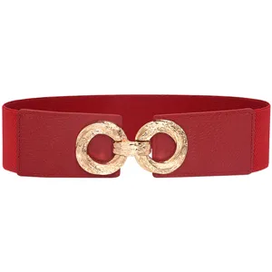 Detailed close up shot of women red elastic waist belt featuring gold metal ring buckle.