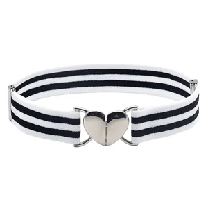 Women's elastic waist belt with black and white stripes and silver heart buckle accessory.