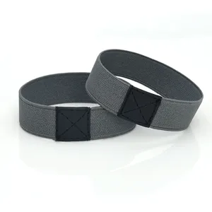 Detailed shot of elastic high heel shoe straps in gray with black leather patch connectors.