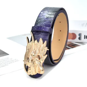 Detail shot of punk purple snakeskin leather belt featuring a bold gold dragon head buckle.