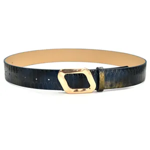 Close-up detail of stylish women belt with unique geometric gold buckle and blue texture strap.