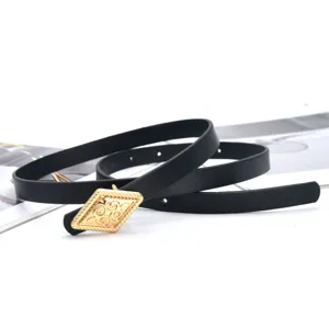 Detail view of a stylish black thin belt with a chic gold diamond buckle for dresses.