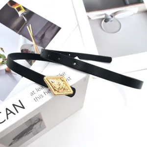 Women's black skinny leather belt featuring a vintage gold rhombic buckle for dress styling.
