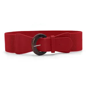 Close up view of red wide elastic waist belt with vintage wood grain round buckle detail.