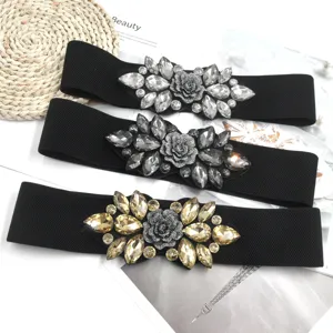 Elegant black elastic waist belt set with sparkling crystal rhinestone floral buckles.