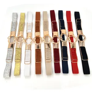 Close-up of various colored women elastic waist belts with shiny gold ring buckles detail.