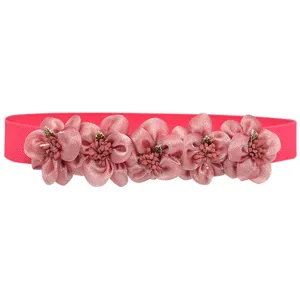 Detailed close-up view of pink elastic waist belt with exquisite fabric flower ornaments.