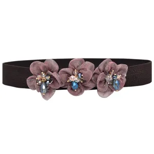 Close-up detail of rhinestone flower elastic waist belt decorative accessory for dress.