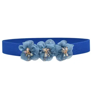 Blue elastic waist belt for women featuring three chiffon flowers and sparkling rhinestone details.