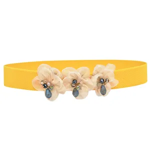 Women yellow elastic waist belt with floral fabric and rhinestones, stylish dress accessory.