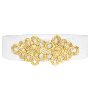 Detailed closeup of a white elastic waist belt featuring an intricate gold braided knot buckle.