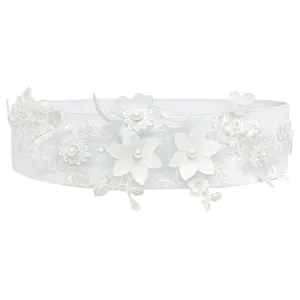 Detail view of white elastic waist belt featuring delicate lace floral embroidery and faux pearls.