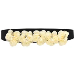 Black elastic waist belt featuring five cream sheer fabric flowers and metal leaf accent.