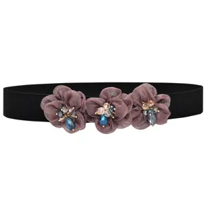 Black elastic waist belt featuring three rhinestone flower decorations for sweet dress fashion styling.