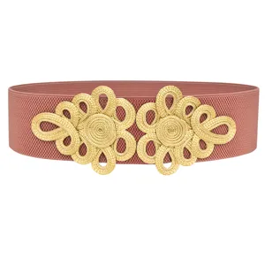 Detail view of wide elastic waist belt with gold Chinese knot design for dresses