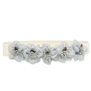 Women elastic waist belt with grey floral detail, fashionable dress decorative band.