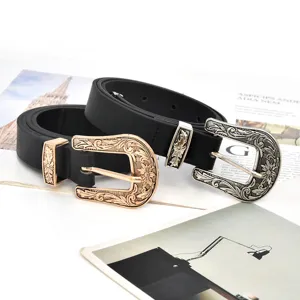 Close-up detail of retro engraved metal buckle black leather belt, vintage floral carved design.