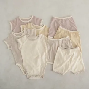 Infant ribbed bodysuit and shorts set detail, soft contrast trim knit fabric, summer baby wear.