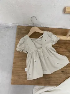Toddler girl summer embroidered cotton dress with puff sleeves and floral details, back cross strap.