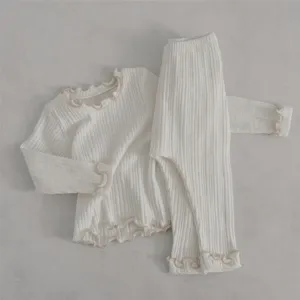 Soft ribbed baby girl long-sleeve top and pants set with cute lettuce edge details.