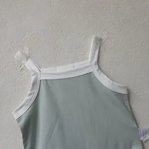 Closeup detail of the sage green baby tank top romper with white trim. Perfect for summer days.