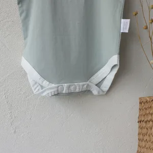 Baby light green cotton romper detail, comfortable summer infant snap bodysuit for daily wear.