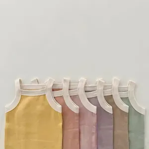 Detail shot of colorful cotton baby strap rompers, soft pastel newborn sleeveless bodysuits