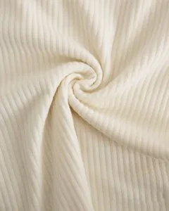 Beige cotton ribbed fabric detail, soft texture and comfortable stretch for baby wear.