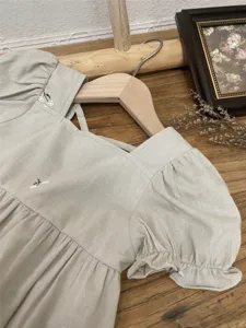 Cute toddler girls summer linen dress with embroidered floral details and puff sleeves.